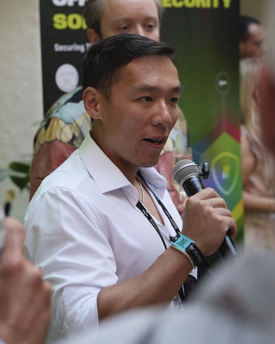 Kai Huang speaking with neighbors at a community event